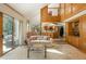 Spacious living room with a soaring ceiling, natural light, and an adjacent kitchen and dining area at 5063 E Otero Cir, Centennial, CO 80122