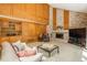 Comfortable living room featuring a brick fireplace, built-in shelving, and a relaxing atmosphere at 5063 E Otero Cir, Centennial, CO 80122