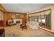 Inviting living room with a wood-paneled accent wall, fireplace, and large picture window at 5063 E Otero Cir, Centennial, CO 80122