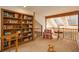 Cozy loft area features a bookcase, comfortable chair, table, and natural light from a skylight at 5063 E Otero Cir, Centennial, CO 80122