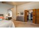 The main bedroom has an attached ensuite, dresser, and closet with open doors at 5063 E Otero Cir, Centennial, CO 80122
