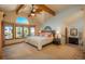 The main bedroom has wooden beams, multiple windows with backyard views, and an ensuite at 5063 E Otero Cir, Centennial, CO 80122