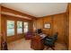 Handsome office with wood paneling, built-in bookshelves, and a large wooden desk at 5063 E Otero Cir, Centennial, CO 80122