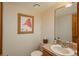 Cozy powder room featuring a unique sink, decorative mirror, and charming artwork at 5063 E Otero Cir, Centennial, CO 80122