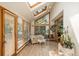 Bright sunroom with skylights and windows, furnished with a white wicker seating set at 5063 E Otero Cir, Centennial, CO 80122