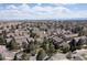 Overhead view of a neighborhood with well-maintained homes, mature trees, and landscaping under a partly cloudy sky at 10183 Grove Loop # D, Westminster, CO 80031