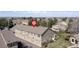 An aerial of townhomes featuring private garages, well-kept lawns, and lush surrounding trees at 10183 Grove Loop # D, Westminster, CO 80031