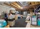 Unfinished basement space filled with storage boxes, shelving, and exposed ceiling with carpeting at 10183 Grove Loop # D, Westminster, CO 80031