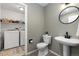Half bathroom with washing machine and dryer in the background at 10183 Grove Loop # D, Westminster, CO 80031