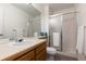 Bright bathroom features a large mirror, vanity with sink, and a glass-enclosed shower for a clean aesthetic at 10183 Grove Loop # D, Westminster, CO 80031