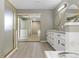 Bathroom showcasing updated vanity with double sinks, mirrors, soaking tub, and sliding glass door shower at 10183 Grove Loop # D, Westminster, CO 80031