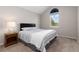 Comfortable bedroom featuring a queen size bed, window and lamp on bedside table at 10183 Grove Loop # D, Westminster, CO 80031