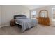 Cozy bedroom features neutral decor, comfortable bedding, and a wooden dresser at 10183 Grove Loop # D, Westminster, CO 80031