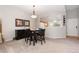 Cozy dining area with dark wood table set and decor, adjacent to the kitchen at 10183 Grove Loop # D, Westminster, CO 80031