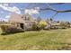 Townhome displaying well-manicured lawn, decorative landscaping, and welcoming front entryway with a bench at 10183 Grove Loop # D, Westminster, CO 80031