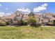Townhome showcasing green lawn, lovely landscaping, and stylish architectural detail with a bench out front at 10183 Grove Loop # D, Westminster, CO 80031