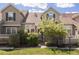 Charming townhome featuring stone accents, landscaped front yard, and a welcoming facade at 10183 Grove Loop # D, Westminster, CO 80031