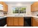 Kitchen with oak cabinetry, laminate counter tops, and stainless steel appliances at 10183 Grove Loop # D, Westminster, CO 80031