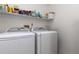 Functional laundry room featuring a washer, dryer, and ample shelving for storage and organization at 10183 Grove Loop # D, Westminster, CO 80031