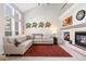 Bright living room featuring a fireplace, high ceilings, large windows and comfortable seating, perfect for relaxing and entertaining at 10183 Grove Loop # D, Westminster, CO 80031