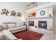 Elegant living room with a fireplace, artwork, a clock, and a comfortable sectional sofa at 10183 Grove Loop # D, Westminster, CO 80031