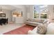 Bright living room with tall windows, comfortable sofa, and open layout to the kitchen at 10183 Grove Loop # D, Westminster, CO 80031