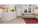 Inviting living room filled with natural light showcasing a comfortable couch, open doorway to the kitchen, and front door at 10183 Grove Loop # D, Westminster, CO 80031