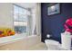 Bathroom with a bathtub, toilet and city views at 300 W 11Th Ave # 18C, Denver, CO 80204