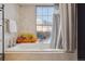 Bathroom with a bathtub and city views at 300 W 11Th Ave # 18C, Denver, CO 80204