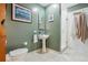 Updated bathroom with pedestal sink, shower, and toilet at 300 W 11Th Ave # 18C, Denver, CO 80204