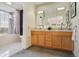 Double vanity bathroom with light wood cabinets at 300 W 11Th Ave # 18C, Denver, CO 80204