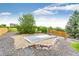 Well-manicured backyard featuring a basketball court, gravel area, and mature trees at 12000 Horseshoe Ln, Parker, CO 80138