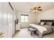 Bright bedroom features a ceiling fan, closet, and a large window, creating a comfortable and inviting space at 12000 Horseshoe Ln, Parker, CO 80138