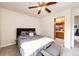 Well-lit bedroom has a ceiling fan and an ensuite bathroom, offering convenience and privacy at 12000 Horseshoe Ln, Parker, CO 80138