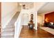 Bright foyer with hardwood floors, staircase, and views into the living and dining areas at 12000 Horseshoe Ln, Parker, CO 80138