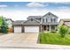Charming two-story home with a three car garage, covered porch and landscaped front yard at 12000 Horseshoe Ln, Parker, CO 80138