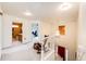 Bright hallway with a view of an office, a bathroom, and the staircase to the lower level at 12000 Horseshoe Ln, Parker, CO 80138