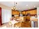 Bright kitchen with wooden cabinets, center island and a casual dining area with table setting at 12000 Horseshoe Ln, Parker, CO 80138