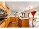 Open concept kitchen with wooden cabinets, center island, stainless appliances and adjacent dining area at 12000 Horseshoe Ln, Parker, CO 80138