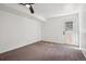 Finished basement features neutral carpet, a drop ceiling, and a walk-out door to the backyard at 3247 S Newland St, Denver, CO 80227