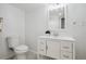 Bright bathroom featuring updated vanity, modern fixtures, mirror, and tiled flooring at 3247 S Newland St, Denver, CO 80227