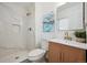 Modern bathroom showcasing marble tiled shower, sleek vanity, designer mirror and updated fixtures at 3247 S Newland St, Denver, CO 80227