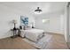 Bright bedroom features wood floors, a modern ceiling fan, and a serene accent wall art at 3247 S Newland St, Denver, CO 80227