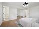 Bright primary bedroom featuring wood flooring, closet with mirror doors and bathroom access at 3247 S Newland St, Denver, CO 80227