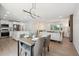 Inviting dining area next to the kitchen and living spaces with a sleek modern chandelier at 3247 S Newland St, Denver, CO 80227