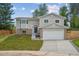 Attractive two-story home with a neatly landscaped front yard and a two-car garage at 3247 S Newland St, Denver, CO 80227