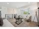 Open living area with comfortable seating, a stylish bay window, and hardwood floors at 3247 S Newland St, Denver, CO 80227