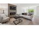 Cozy living room with modern decor, a sleek fireplace, and ample natural light for relaxed living at 3247 S Newland St, Denver, CO 80227