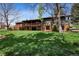 Spacious backyard featuring a lush lawn and a two-story deck, great for outdoor entertainment at 5290 Nassau E Cir, Cherry Hills Village, CO 80113