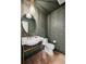 Chic powder room featuring ornate wallpaper, a pedestal sink with gold accents and luxury lighting at 5290 Nassau E Cir, Cherry Hills Village, CO 80113